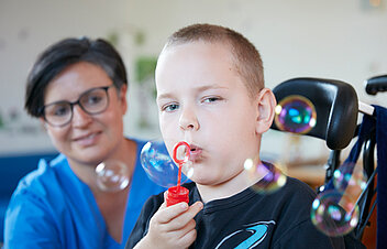 Picture: A patient tries to blow soap bubbles as part of respiratory therapy