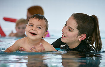 Picture: Patient relaxing in warm water with the support of his therapist